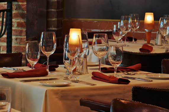La Scala's Elegant Dining Room with Candlelight and Glistening Wine Glasses
